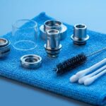 Disassembled vape tank parts with cleaning supplies
